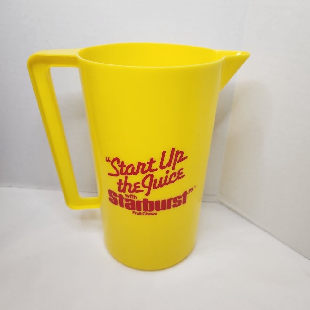 Vintage Yellow Plastic Starburst Pitcher With Retro "Start Up The Juice" Graphic